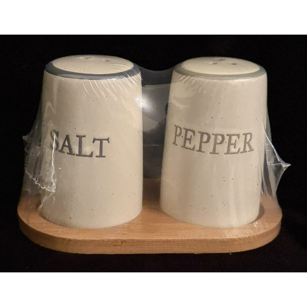 Ceramic Salt and Pepper Shakers on Wooden Stand